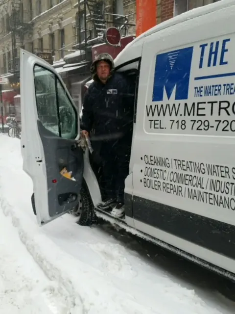 a Metro Group technician stepping out of his van to perform emergency boiler service