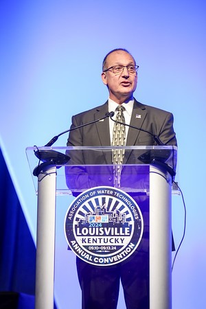 John Caloritis, President of AWT, standing at the Annual Convention speaker's podium